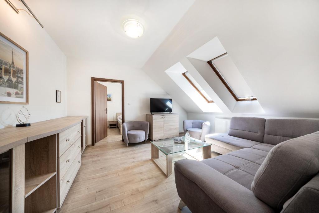 a living room with a couch and a table at Penzión Bergmannhof in Ladomer