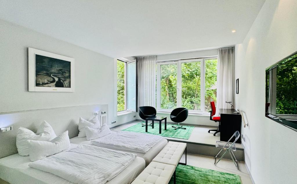 a white room with a bed and a desk at Feldberg4you DesignZimmer in Feldberg