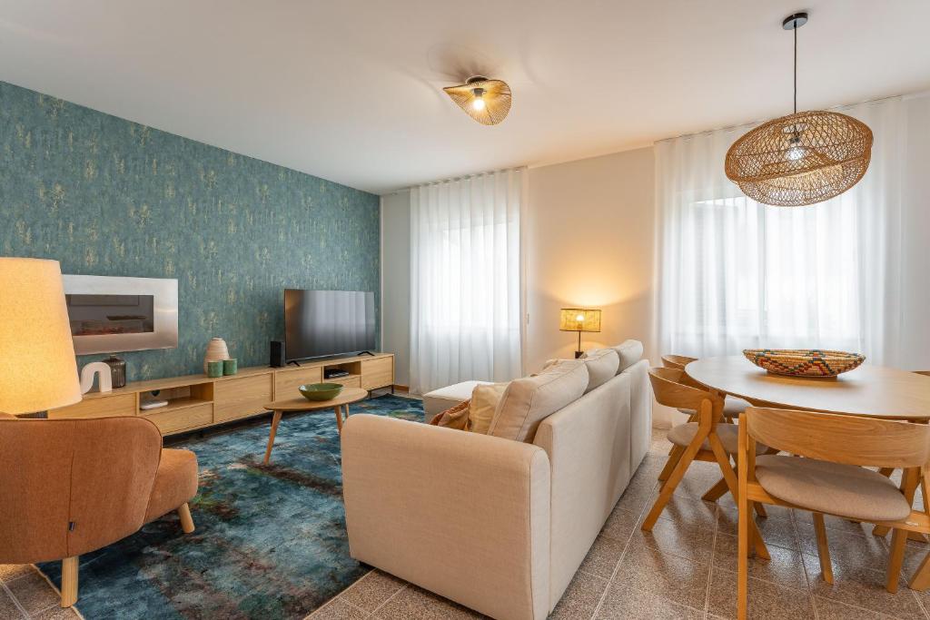 a living room with a couch and a table at Cozy Haven Santana - Nature & Hiking Trails in Santana