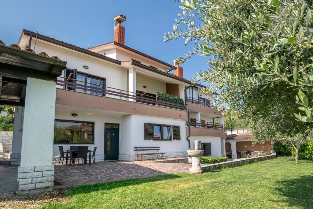 an exterior view of a house with a yard at Prostorni in udobni apartmaji Izola SL - Spacious & Comfortable Apartments Izola SL in Izola