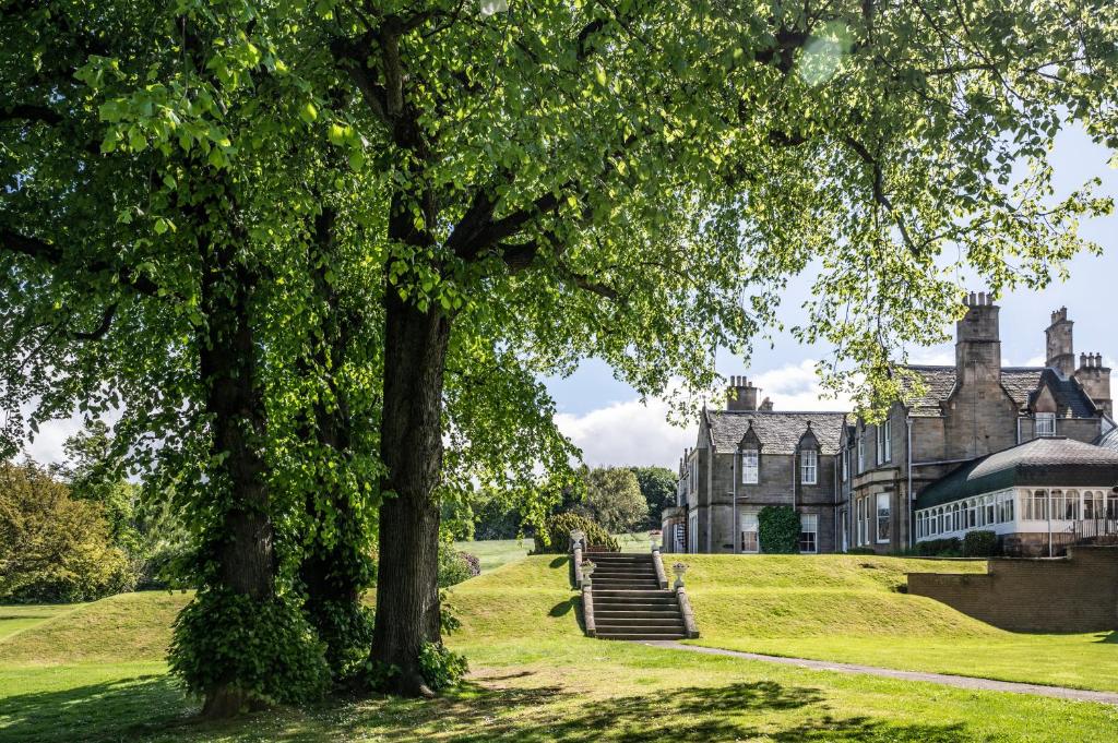 an old mansion with trees in front of it at Norton House Hotel & Spa, Edinburgh in Ingliston