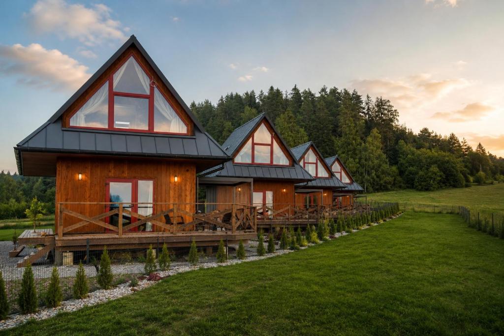 a row of houses on a dock in a field at D'Pazur- sauna, jacuzzi in Białka Tatrzańska