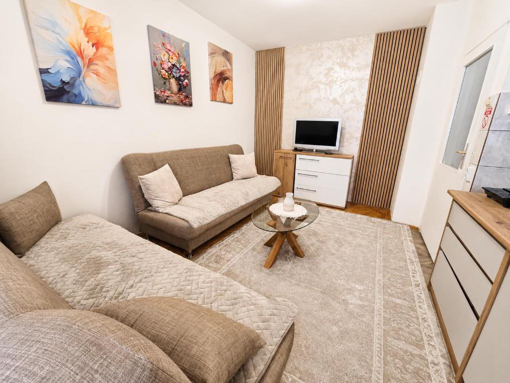 a living room with a couch and a chair at Abrazo in Orašje