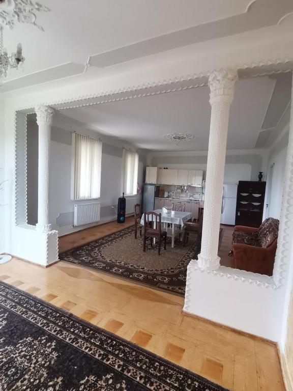 a living room with white columns and a table at Фазенда Оганеса in Ureki
