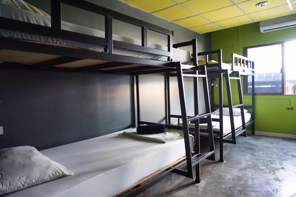 a room with three bunk beds in a building at B&B House & Hostel in Krabi town