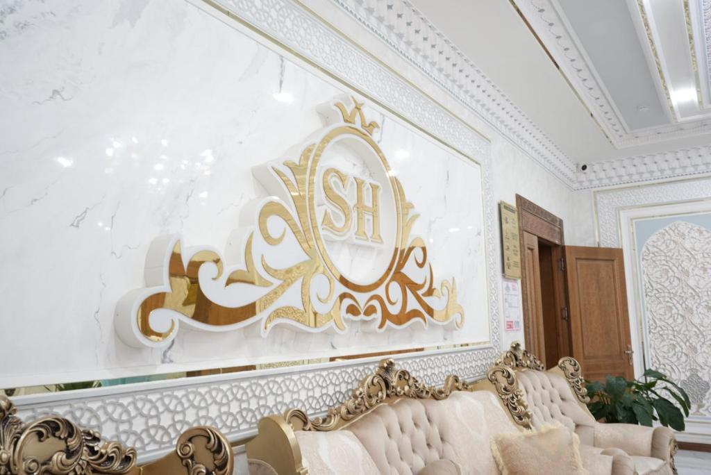 a living room with a couch and a painting on the wall at Shergiron Plaza in Bukhara