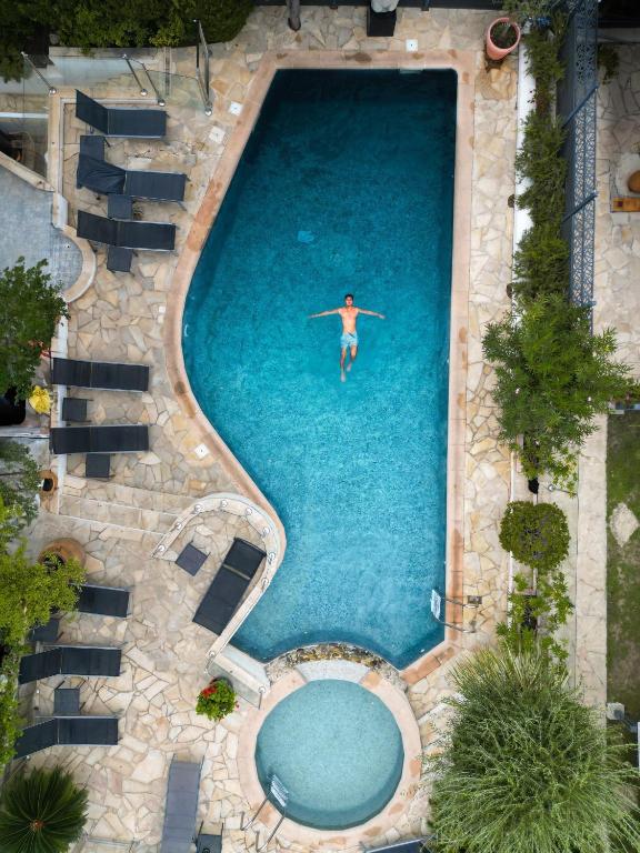 a man is swimming in a swimming pool at Hôtel La Villa Cannes in Cannes