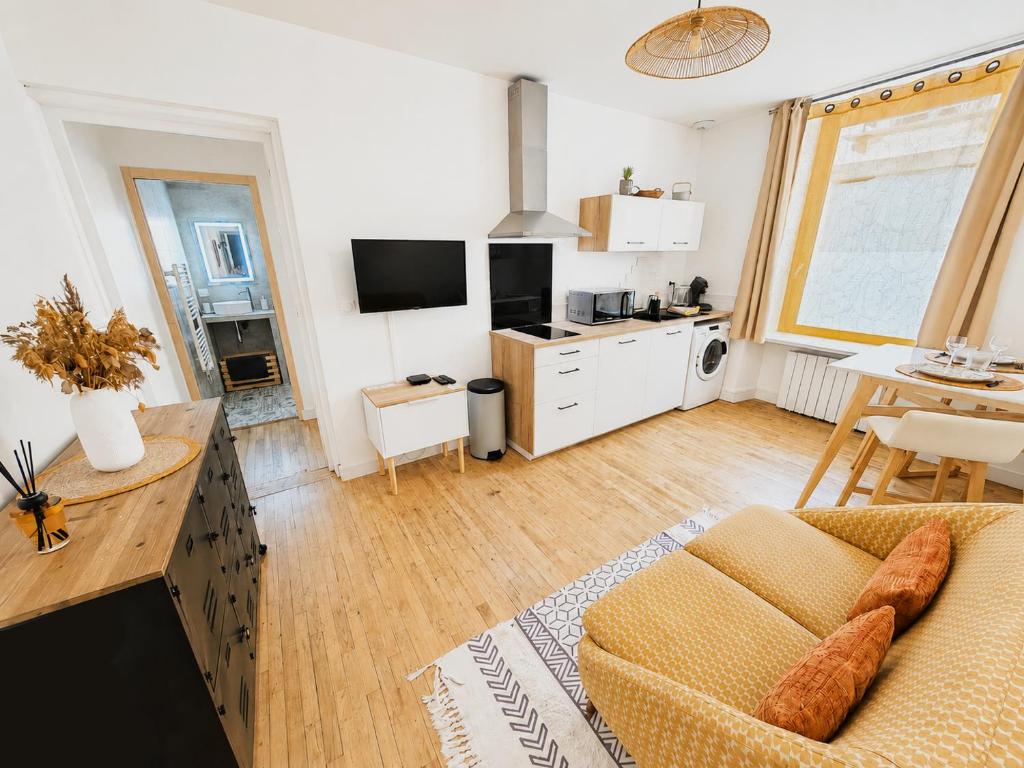 a living room with a couch and a table at Le Byzantin - T2 Hyper centre in Pontivy
