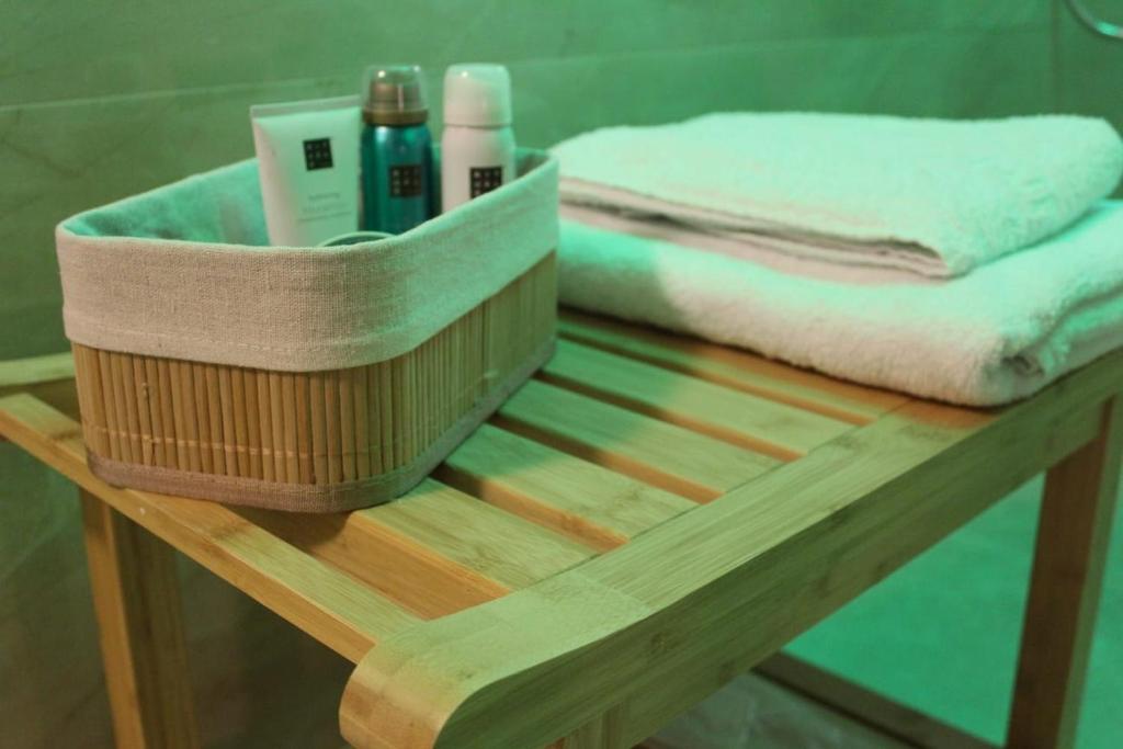 a wooden table with towels and towels on it at Kokoro Lagoon in Saint-André-de-Sangonis