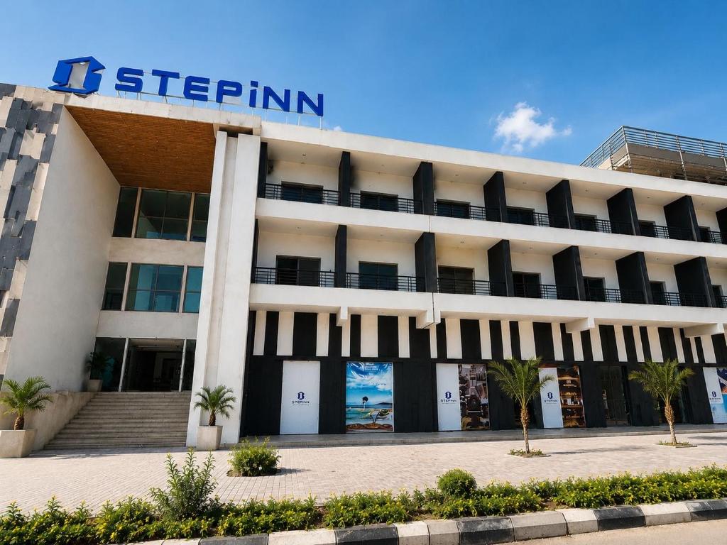 a building with a sign on top of it at StepInn in El Alamein