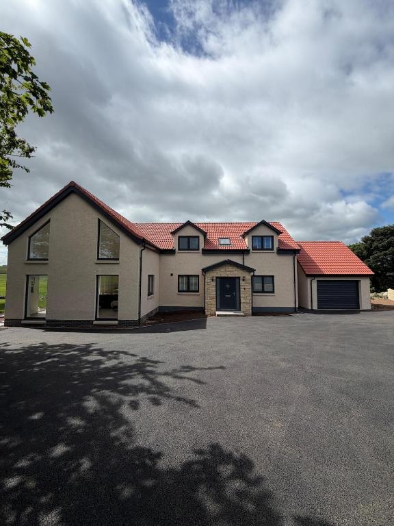 a large white building with a red roof at Cour Cottage in Drem