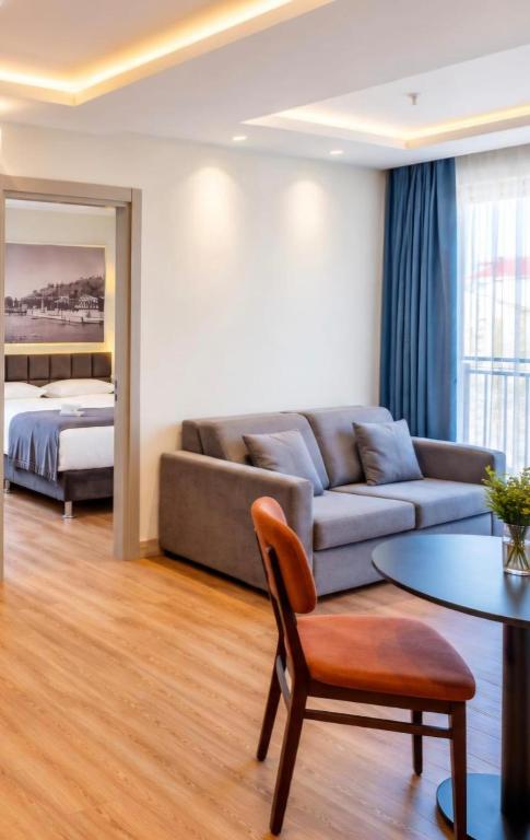 a living room with a couch and a bed at Rai Premium İstanbul in Istanbul