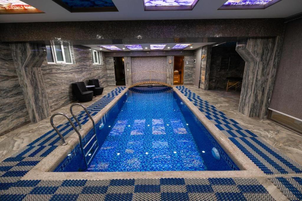 a large swimming pool in a hotel room at Valor Hotel in Tashkent