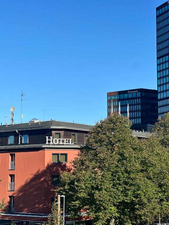 a hotel sign on top of a building with tall buildings at Spar Hotel Gårda in Gothenburg