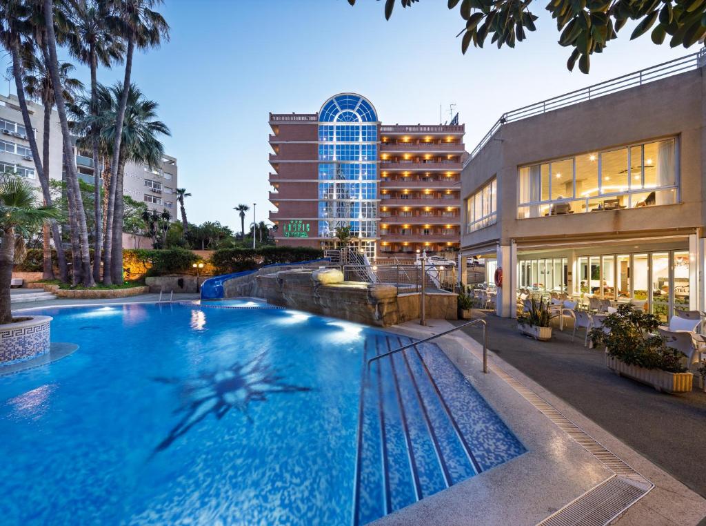 a large swimming pool in front of a building at Hotel Tropic in Cala de Finestrat