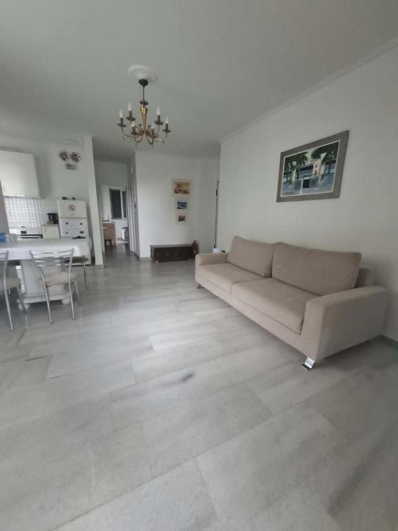 a large living room with a couch and a table at Varkiza Pines Apartment in Varkiza