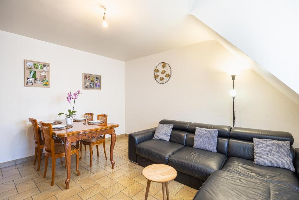 a living room with a couch and a table at Gîte Le Lot in Espalion