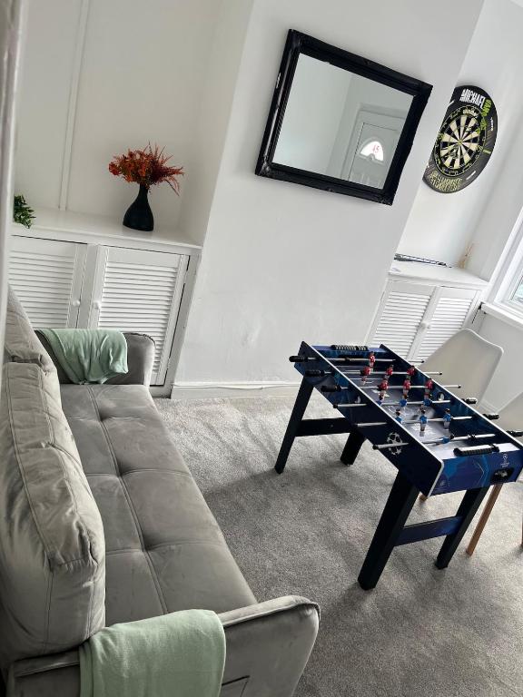 a living room with a chess table and a couch at Scorpio 1 in Burton upon Trent