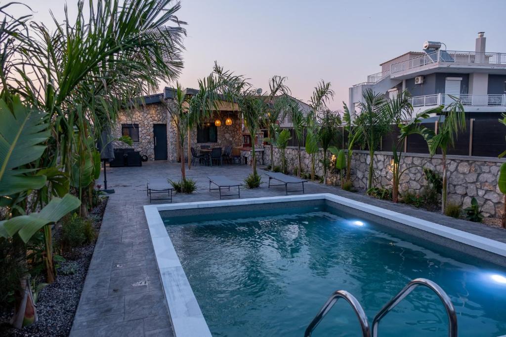a swimming pool in the backyard of a house at Maria - Christina House in Soroni
