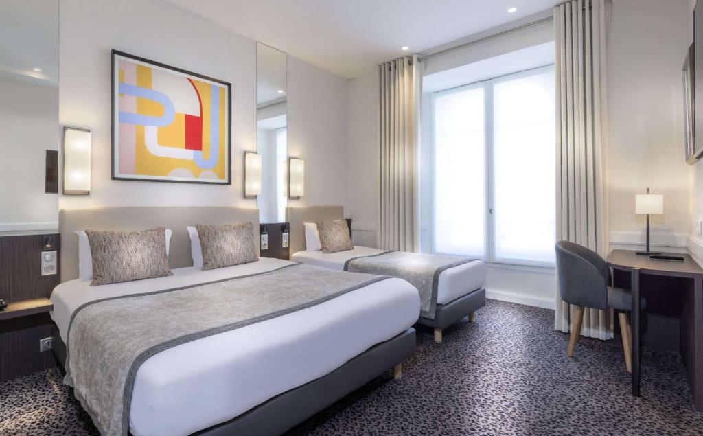 a hotel room with two beds and a desk at Grand Tree Hotel Shree Guru in New Delhi