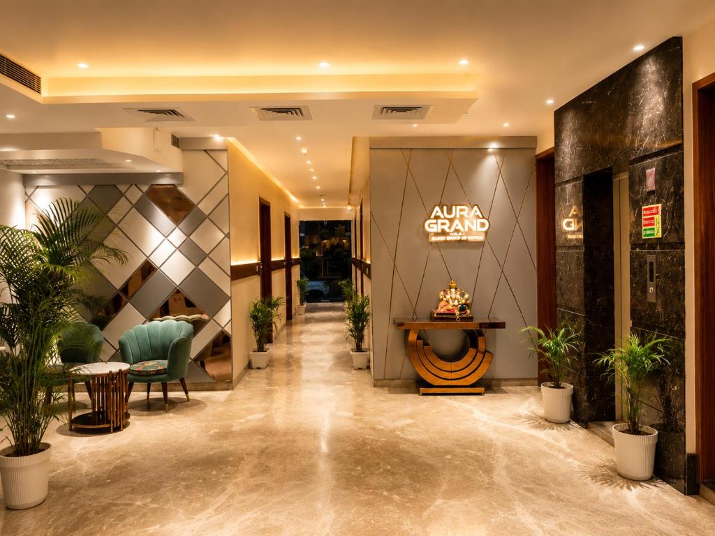 a lobby of a hotel with a sign on the wall at Aura Grand Amritsar in Amritsar