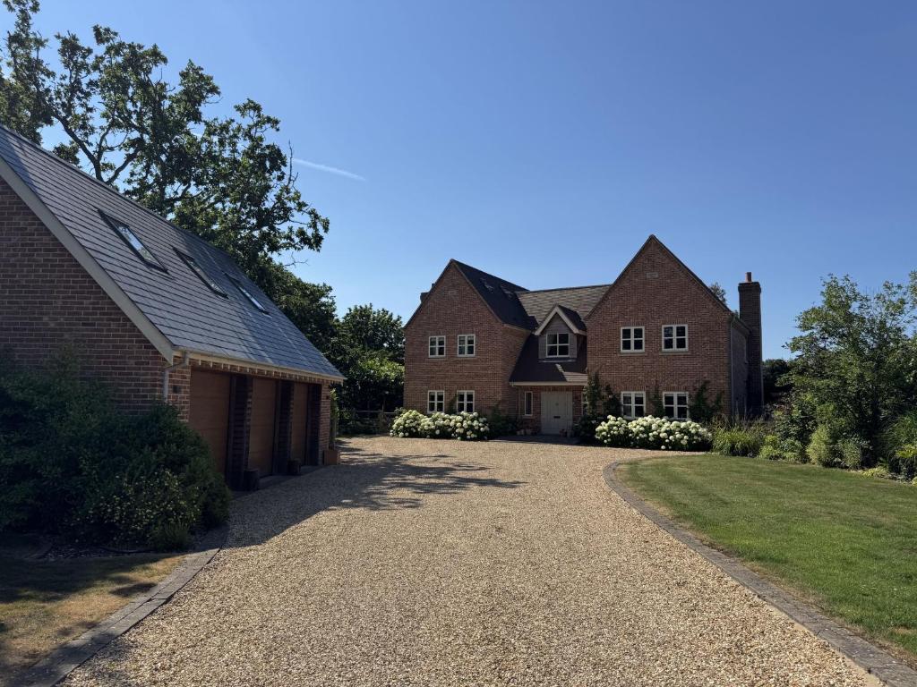a driveway in front of two brick houses at Appletree House in Sway