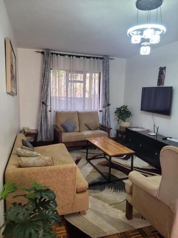 a living room with a couch and a table at Lantana Luxe in Nairobi