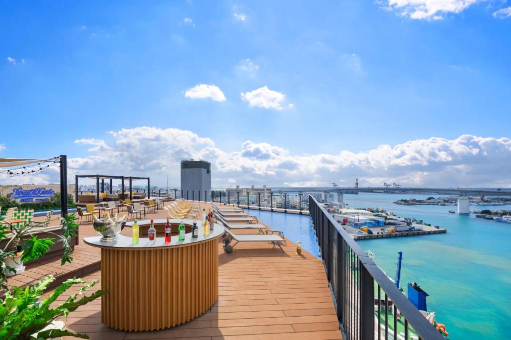 a balcony with a view of the water at South Gate Hotel Okinawa Naha Tomari Port - Direct Access to Tomarin in Naha