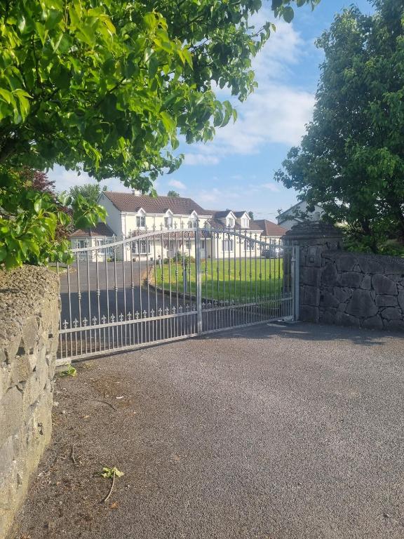 a metal gate in front of a house at Oyster Lodge shared accomadation in Galway