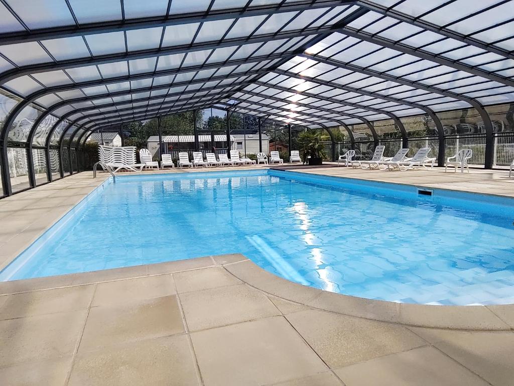 a large swimming pool with a glass roof at Camping La Verte Prairie in Forest-Montiers