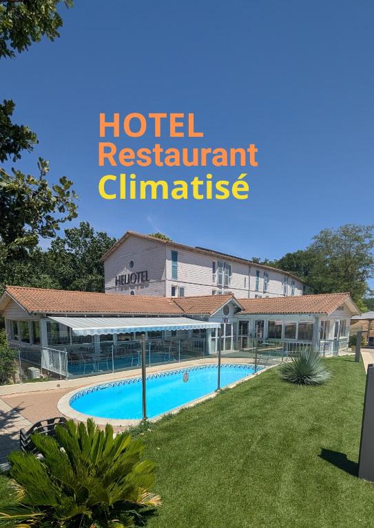 a hotel with a swimming pool in front of a building at Hotel & Restaurant Heliotel in Montferrier-sur-Lez
