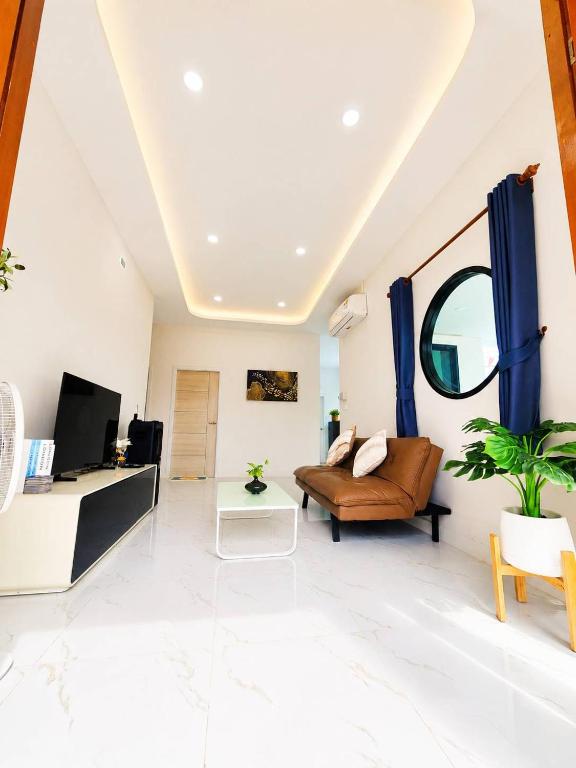 a living room with a couch and a tv at X2 privacy villa in Khon Kaen
