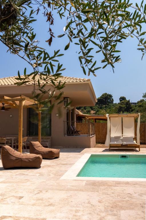 a villa with a swimming pool and a house at Terra Elea Luxury Pool Suite Aura in Nikiti