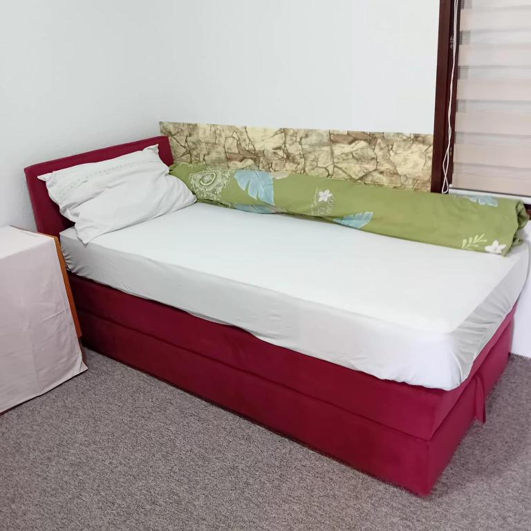 a bed in a room with avertisement for at Kuca za prespavati in Bihać