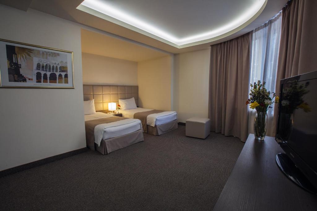 Postel nebo postele na pokoji v ubytování Aviatrans Hotel