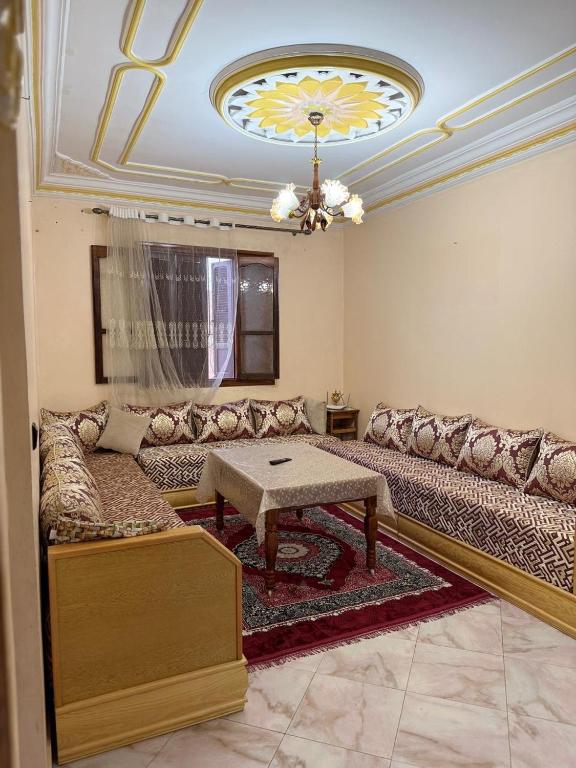 a living room with a couch and a table at Samadis Home 3 in Larache
