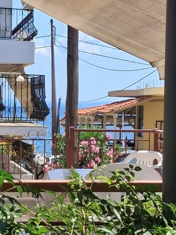 a patio with tables and chairs and the ocean at Kalyves Beach in Kalives Poligirou