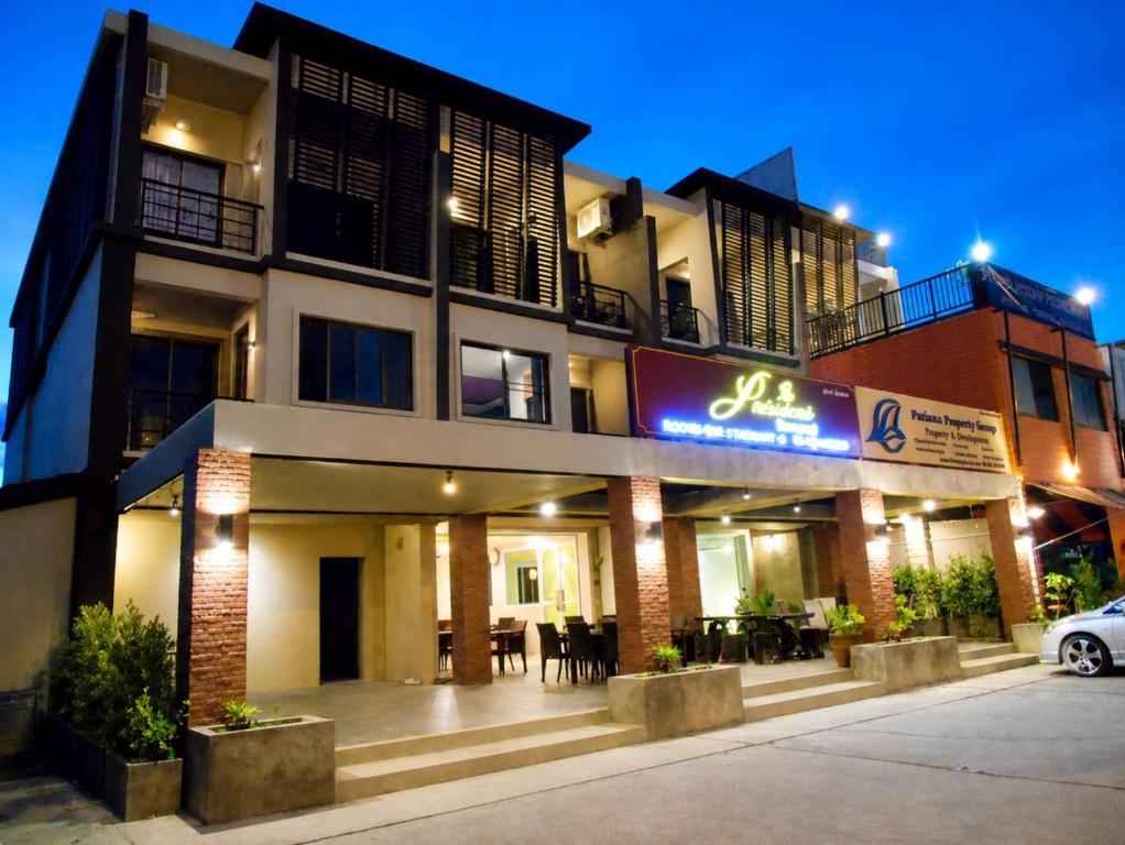 a building with a sign in front of it at Purimas Resortel in Rawai Beach