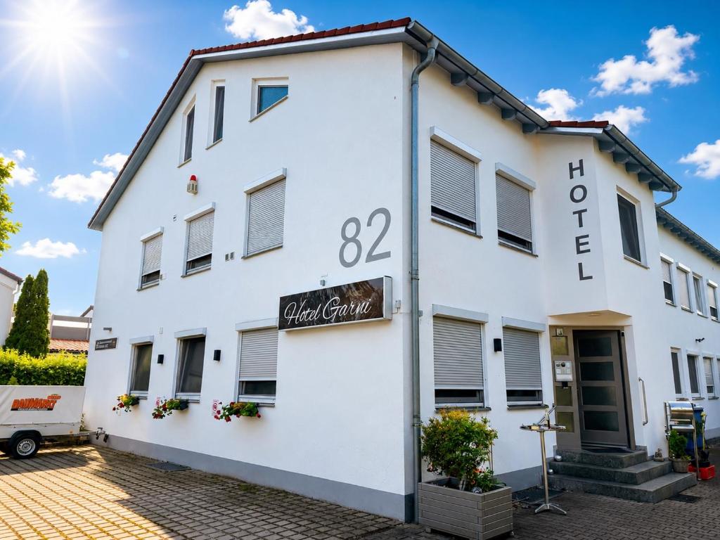 a white building with a sign that reads hotel at Hotel Garni in Burghausen