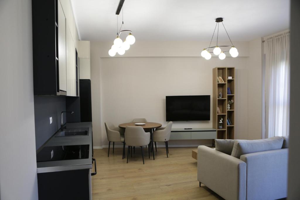 a living room with a table and a couch at Boulevard View in Tirana