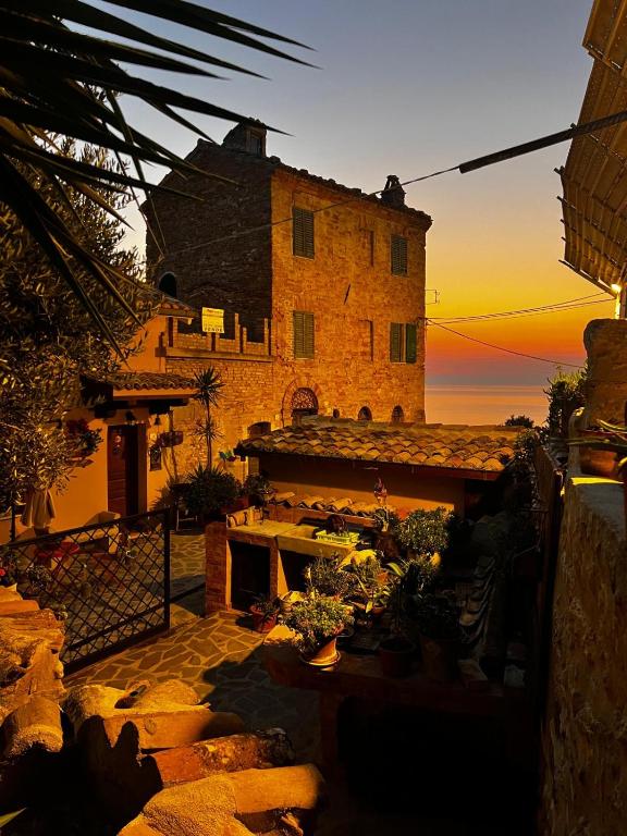 a building with a fireplace in front of a sunset at Zanna Casa Vacanza a soli 450 mt dal mare in Grottammare