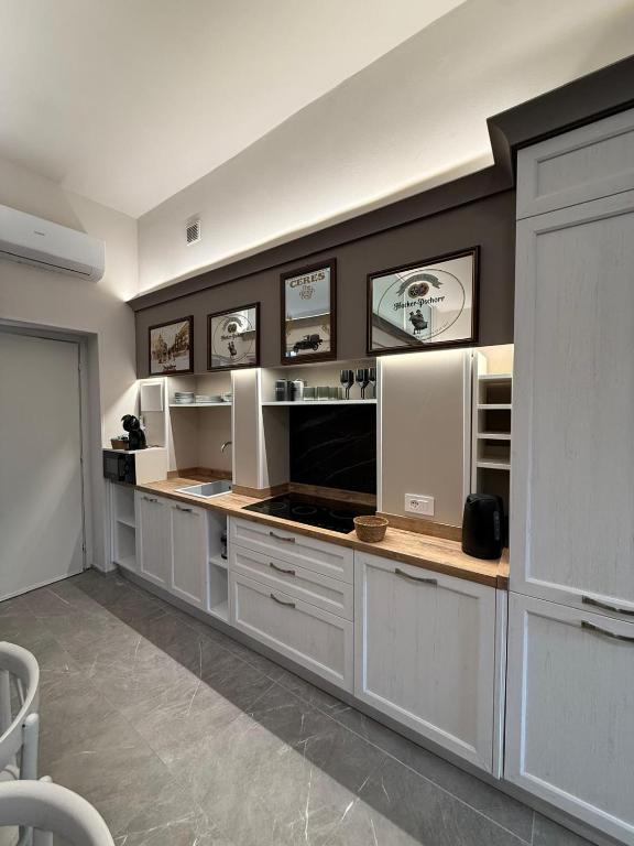 a large kitchen with white cabinets and appliances at Il campanile in Corbetta