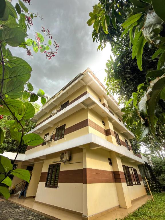 a building with a yellow and brown at Grand Retreat in Trichūr