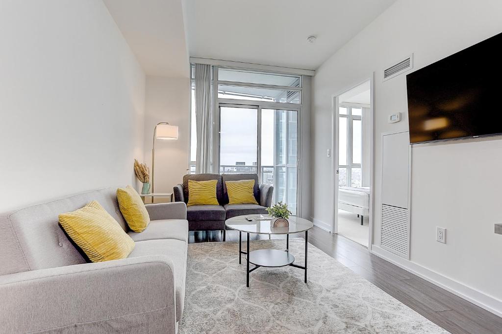 a living room with a couch and a table at Lakeview 1 Bed 1 Den by Rogers Centre in Toronto