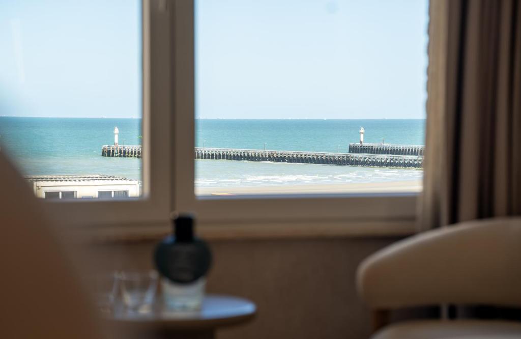 a view of the ocean from a hotel room window at The CORNR Seaview in Nieuwpoort
