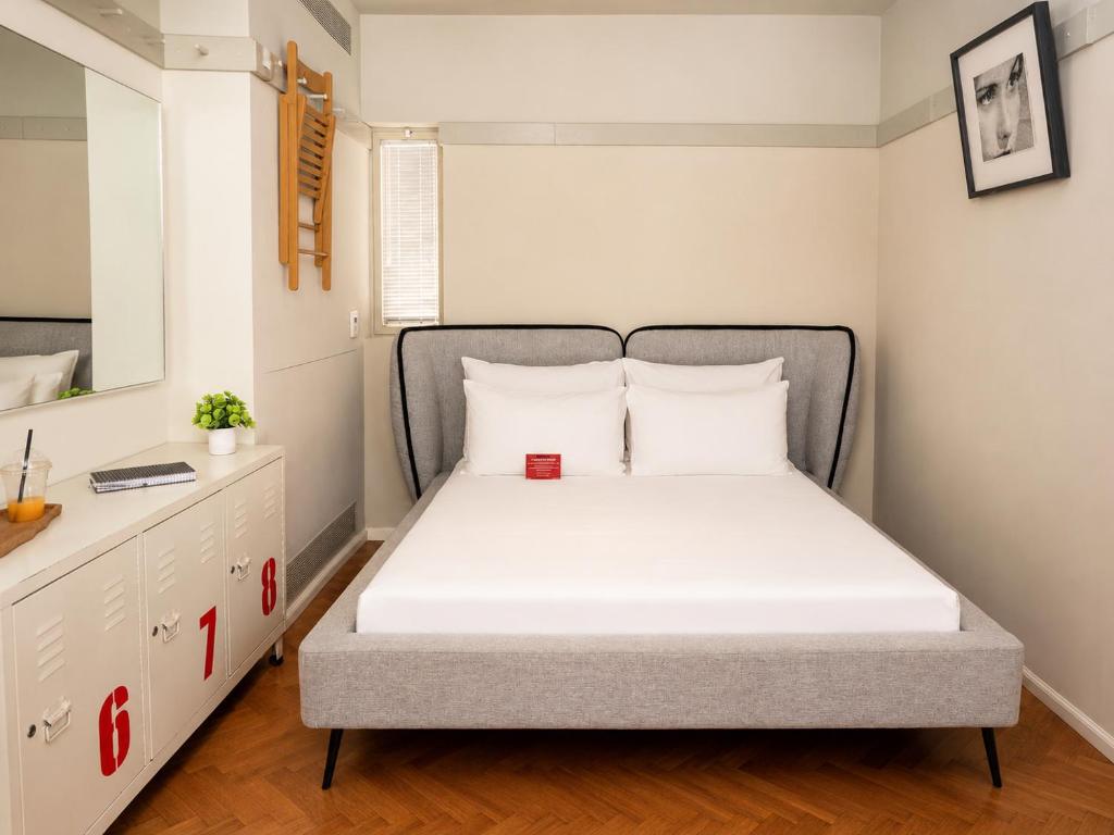 a small bedroom with a bed and a dresser at Florentin House with MAMAK - By HOMY in Tel Aviv
