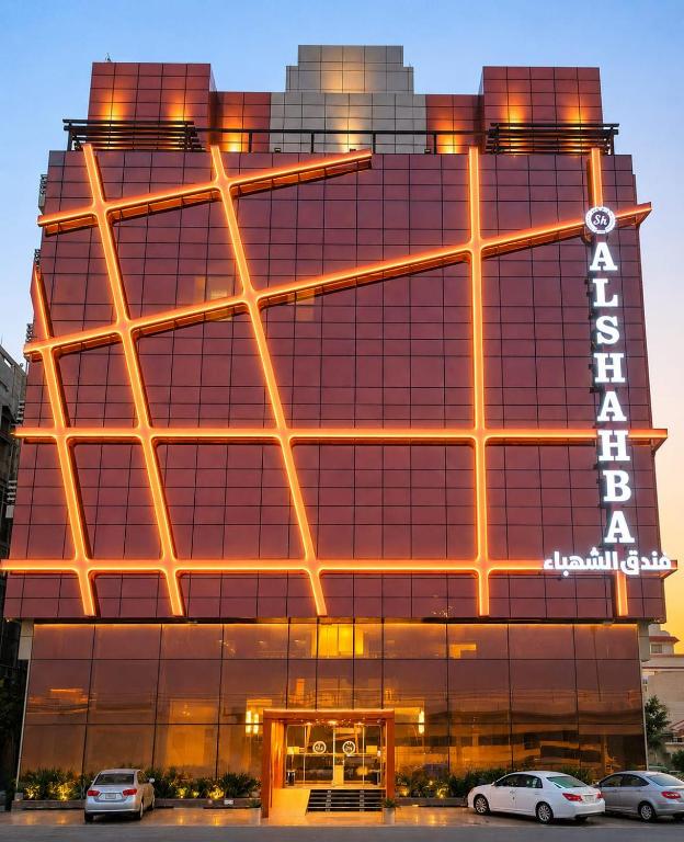 a building with cars parked in front of it at فندق الشهباء جده Al Shahba Jeddah in Jeddah