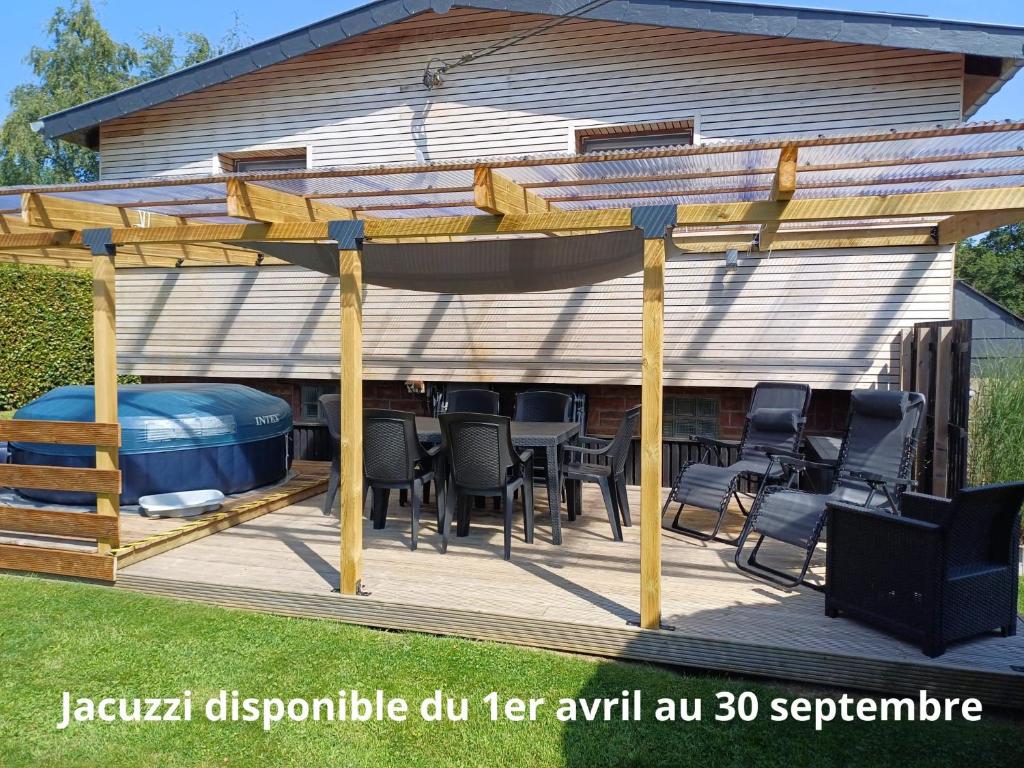 a deck with a gazebo and a hot tub at Le chalet du Ménobu in Theux