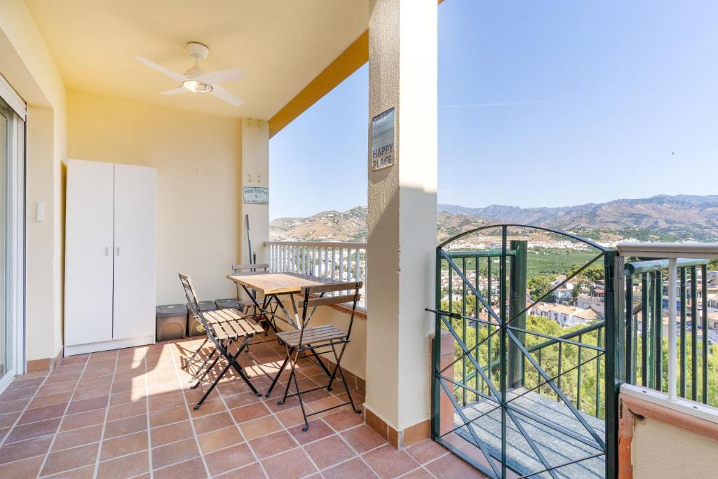 a room with a balcony with a table and chairs at Bellavista Los Pinos in Almuñécar
