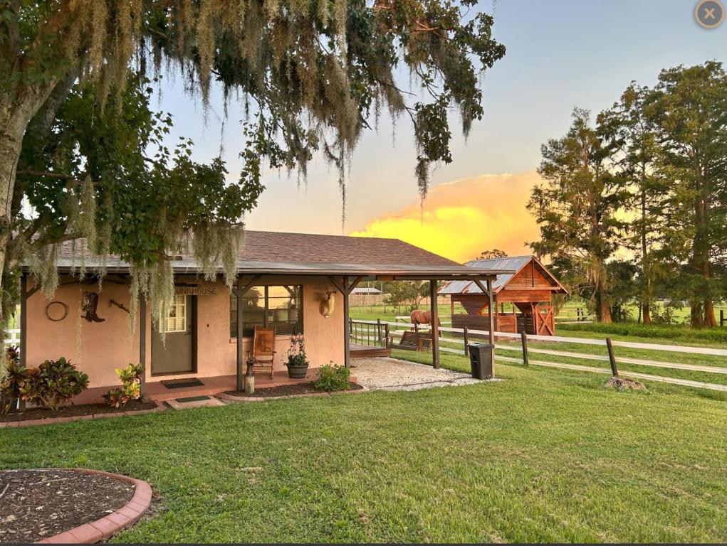 a house with a porch and a fence at The bunkhouse in Sarasota